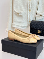 Beige patent leather ballet flats with bow and gold Chanel CC logo
