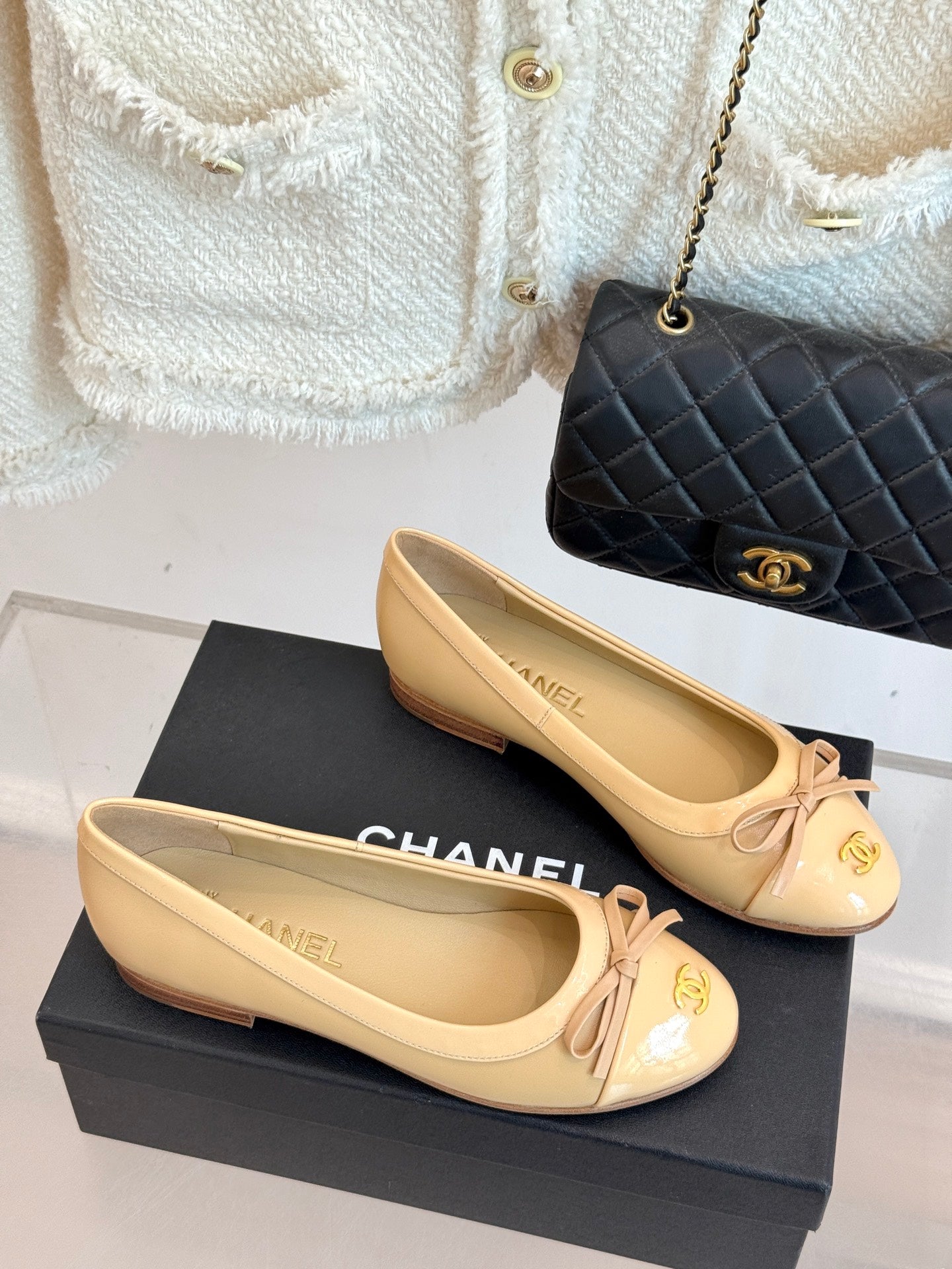 Pair of beige ballet flats with ribbon bow and gold Chanel CC emblem