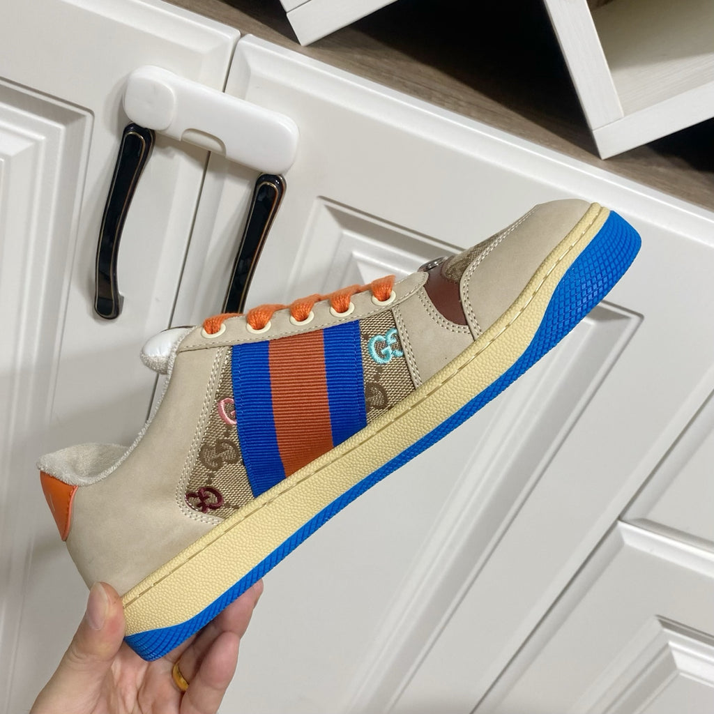 Gucci unisex low-top sneaker, close side view with blue-red stripe and orange laces