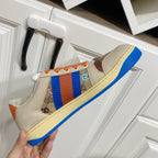 Gucci unisex low-top sneaker, close side view with blue-red stripe and orange laces