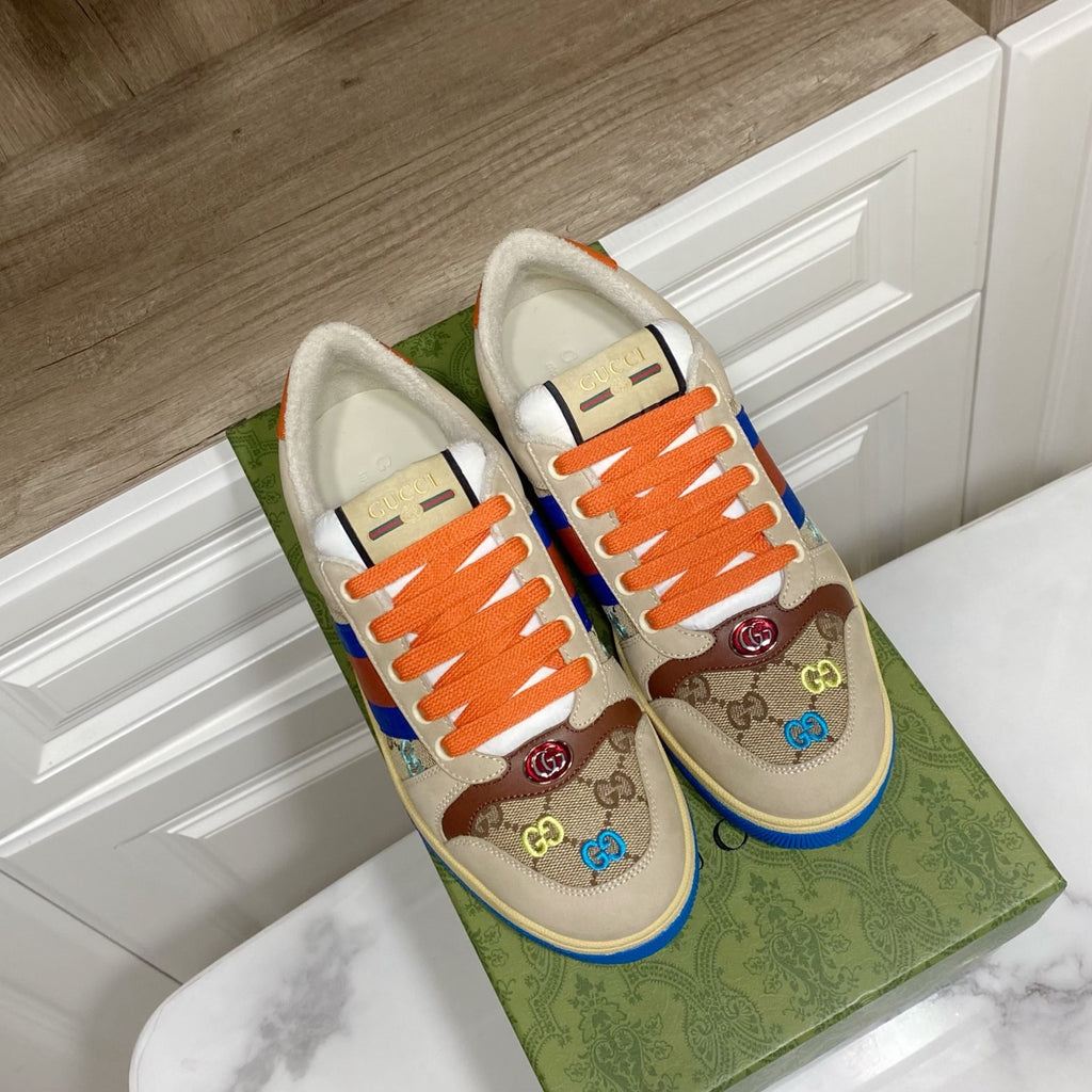 Gucci unisex low-top sneakers, front view with orange laces and blue-red striped panel