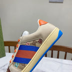 Gucci unisex low-top sneakers, three-quarter view with orange tongue trim and blue sole