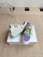 Two low-top sneakers side view: light gray uppers with purple panel and green straps.