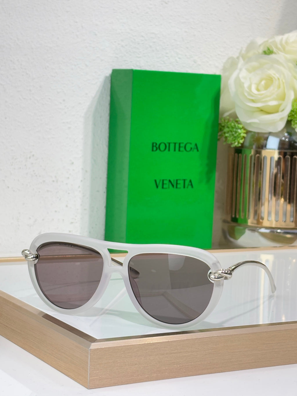 Bottega Veneta sunglasses with light gray frame and dark taupe lenses