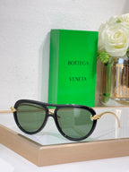 Bottega Veneta sunglasses with black frame and green tinted lenses