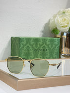 Gucci gold round sunglasses with light lenses and slim metal arms