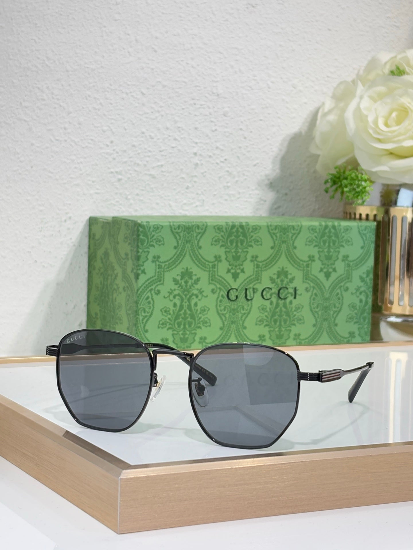 Gucci gold round-frame sunglasses with dark gray lenses and ribbed temples