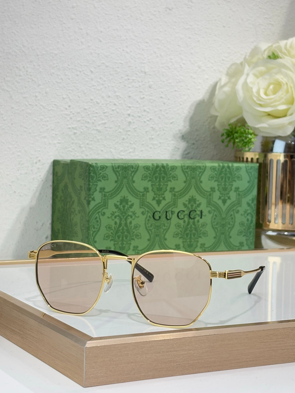 Gucci gold round-frame sunglasses with clear lenses and ribbed metal temples