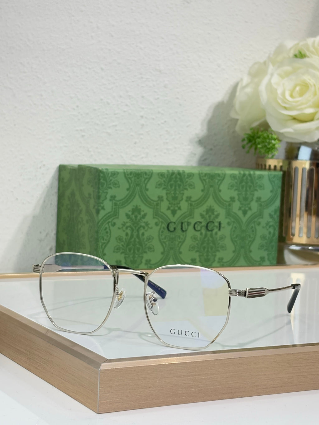 Gucci eyeglasses with dark metal frame and blue-accent temple ends