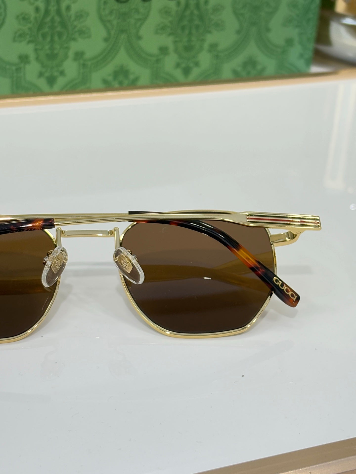 Gucci sunglasses with gold-tone frame and dark tinted lenses