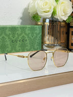 Gucci eyeglasses with gold-tone metal frames and clear lenses