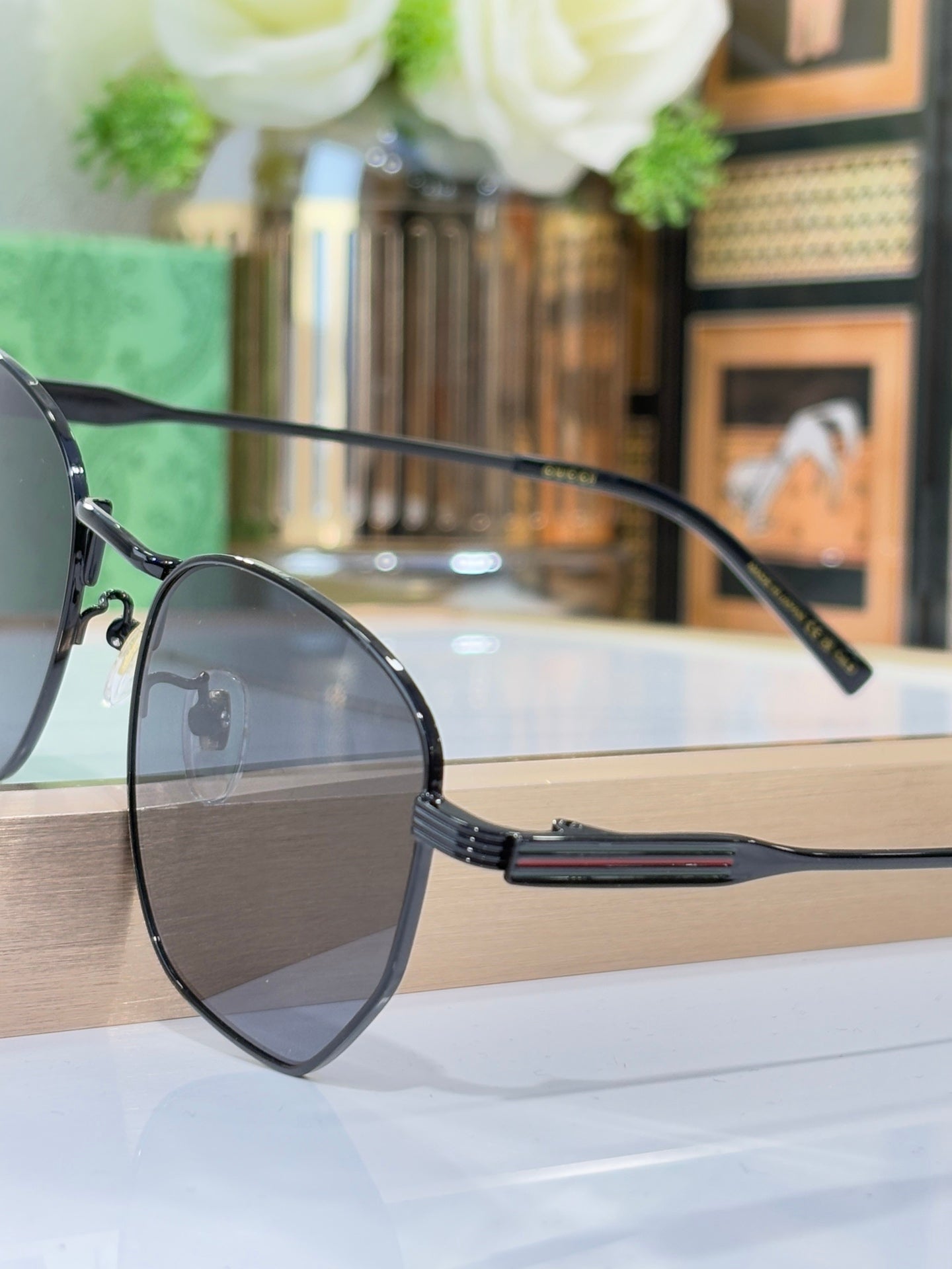 Gucci eyeglasses with dark metal frame and blue-accent temple arm