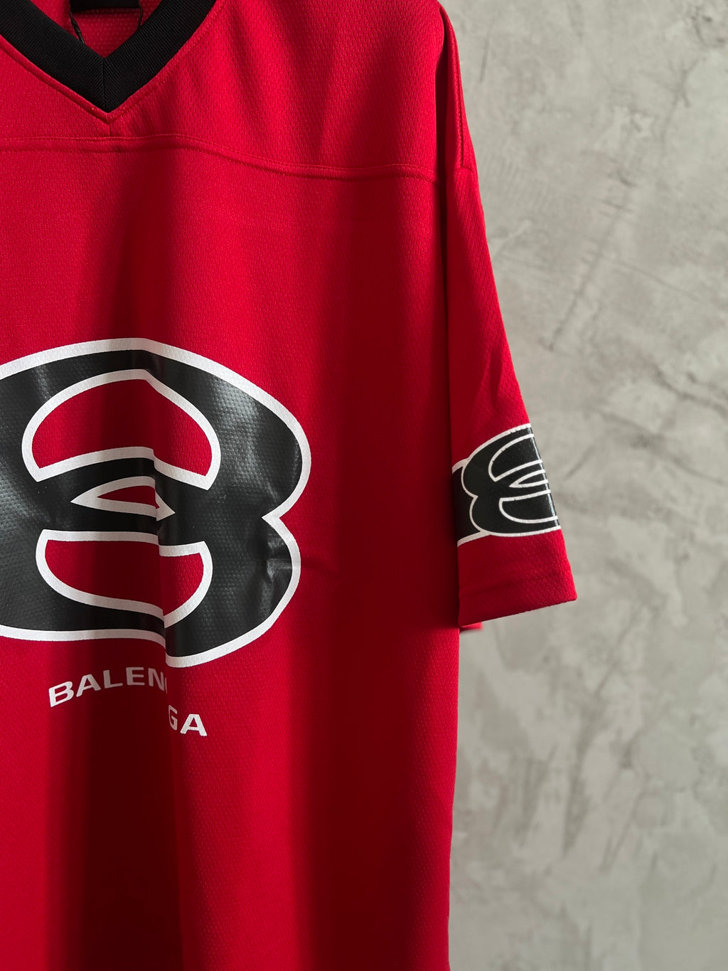 Red V-neck short-sleeve sweatshirt with Balenciaga logo and sleeve graphic