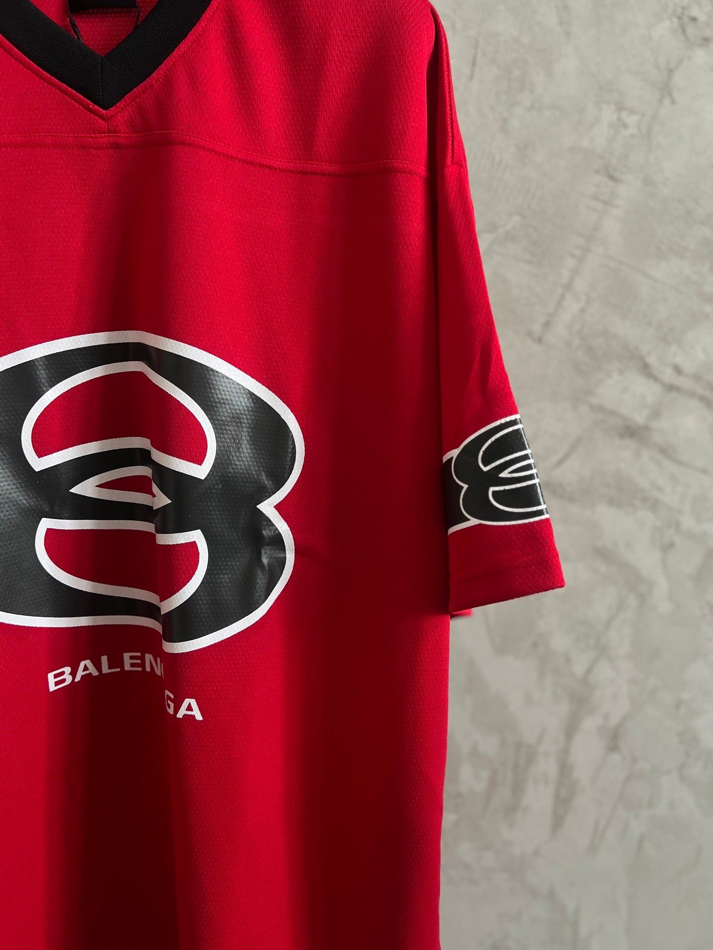Red V-neck short-sleeve sweatshirt with Balenciaga logo and sleeve graphic