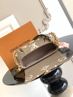 Gray monogram crossbody bag with gold chain strap, front flap, and interior top opening.