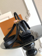 Louis Vuitton monogram mini bag front view with shoulder strap and gold hardware