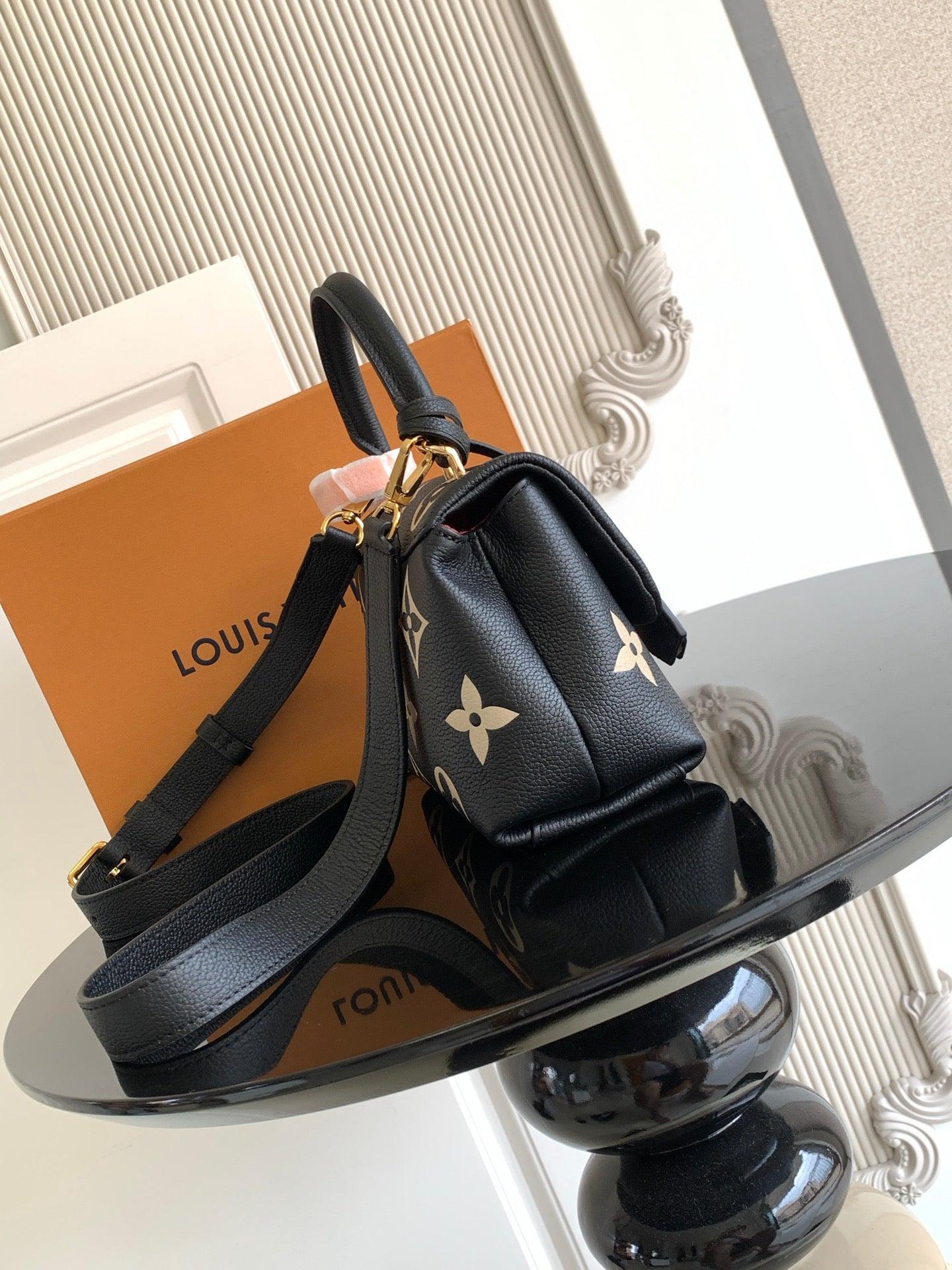 Louis Vuitton monogram mini bag front view with shoulder strap and gold hardware