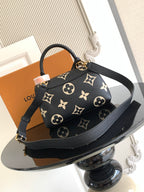 Louis Vuitton monogram mini bag with shoulder strap and gold clasp, black with tan motifs