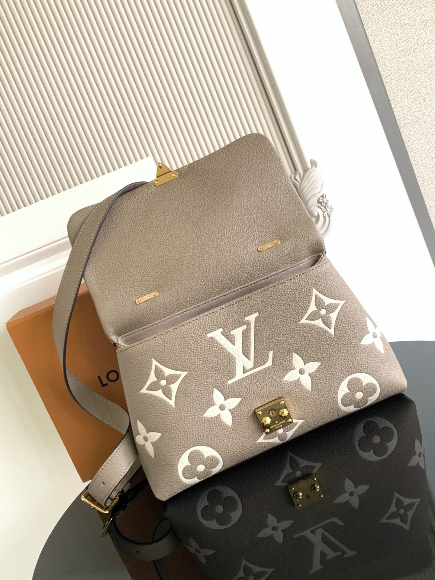 Beige Louis Vuitton crossbody bag with monogram print and gold turn-lock clasp