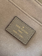 Beige Louis Vuitton Paris label reading "Made in Spain" on bag lining