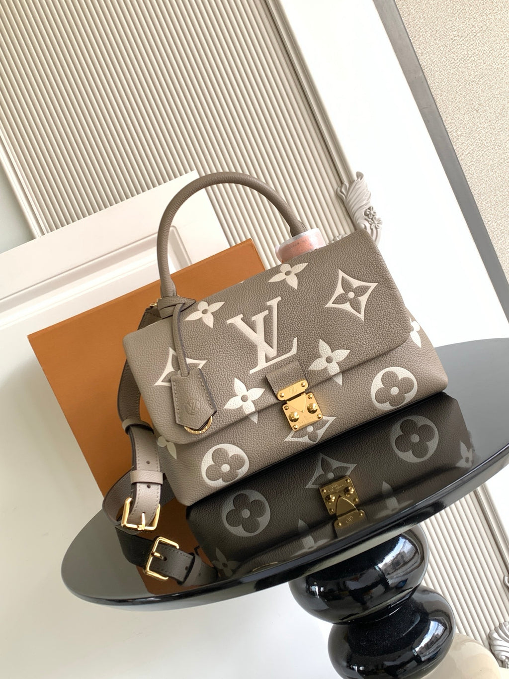 Beige Louis Vuitton top-handle bag with monogram pattern and gold hardware