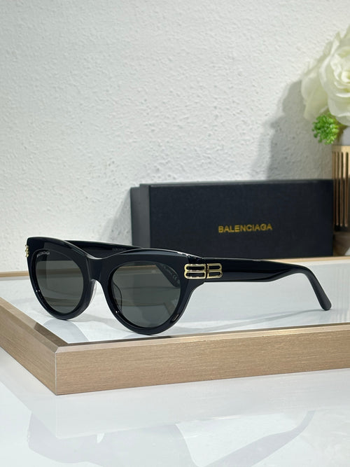 Balenciaga sunglasses with black frame and dark lenses, gold BB emblem on bridge