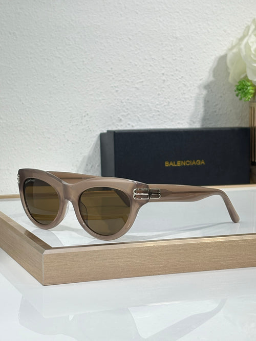 Balenciaga sunglasses with light taupe frame and dark lenses, gold BB emblem on bridge