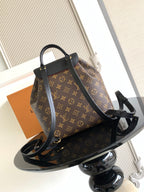 Louis Vuitton monogram bag with black crossbody strap and front clasp hardware