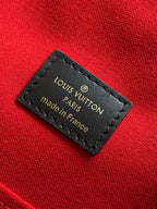 Louis Vuitton made in France label on red fabric lining