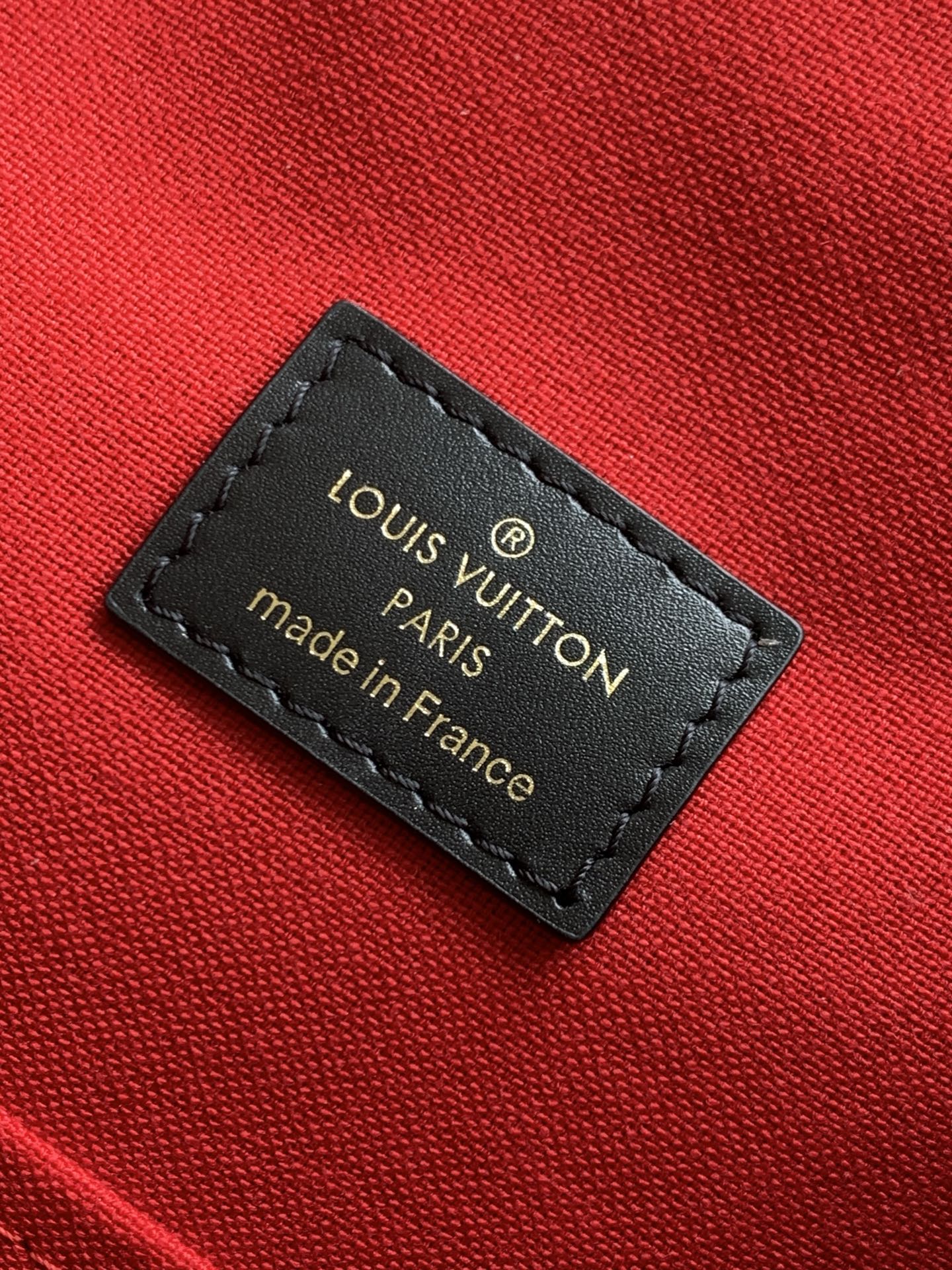 Louis Vuitton made in France label on red fabric lining