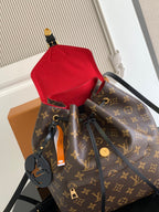 Louis Vuitton monogram bag with red pouch and black straps, gold-tone hardware