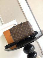 Louis Vuitton monogram bag angled view with black straps and tag detail