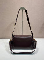Prada leather shoulder bag with long straps and front flap, dark brown.