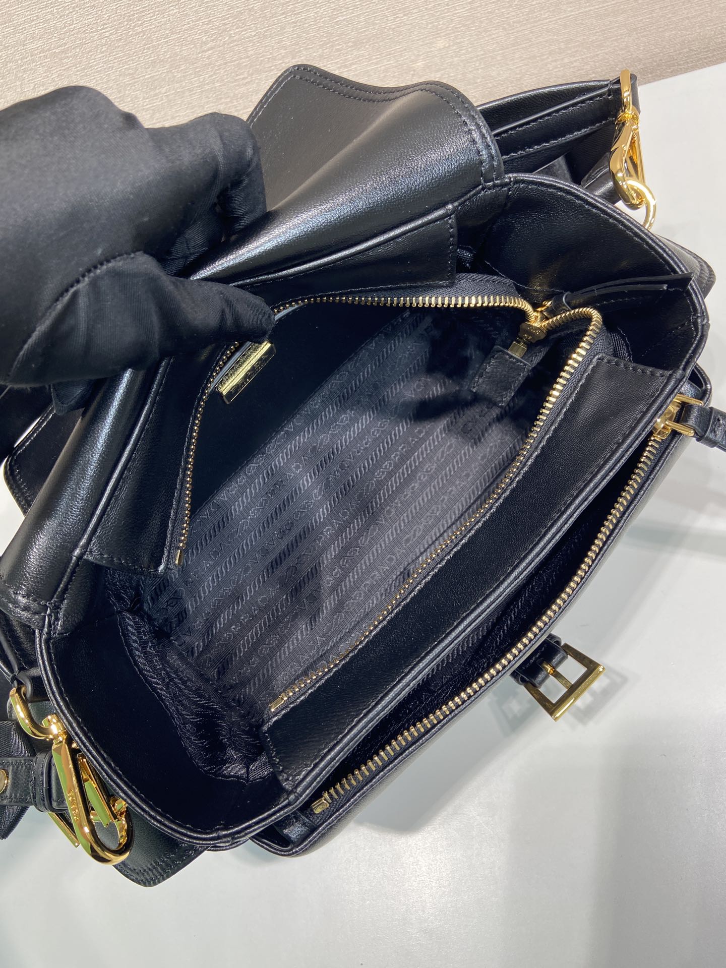 Prada black leather bag interior with zip closure and textured lining.