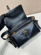 Prada black leather crossbody bag with front flap pocket, belt loops, and gold accents.