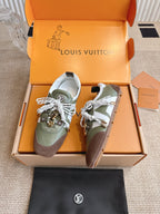 Low-top sneakers with olive uppers, brown side panels, white laces, and logo straps.