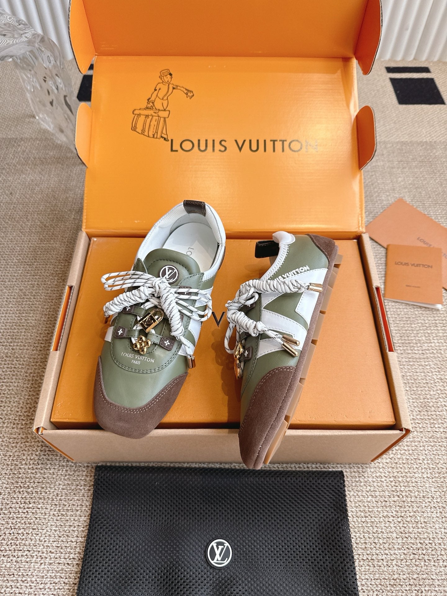 Low-top sneakers with olive uppers, brown side panels, white laces, and logo straps.