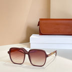 Sunglasses with dark red square frames and red-tinted gradient lenses, gold hinges.