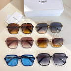 Assorted sunglasses on display: blue, dark, red, and white frames with tinted lenses.