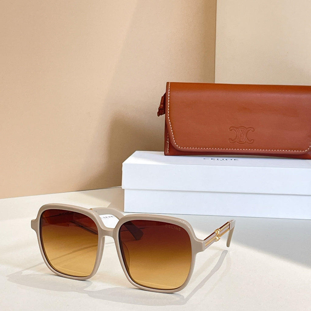 Sunglasses with white square frames and amber-tinted lenses, gold-toned hinges.