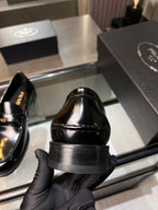 Prada unisex shoes: black patent leather loafer heel view with stacked sole