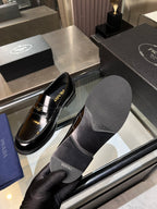Prada unisex shoes: black patent leather loafers with gold hardware, with gray insole cover