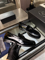 Prada unisex patent loafers, black glossy upper with PRADA detail on strap