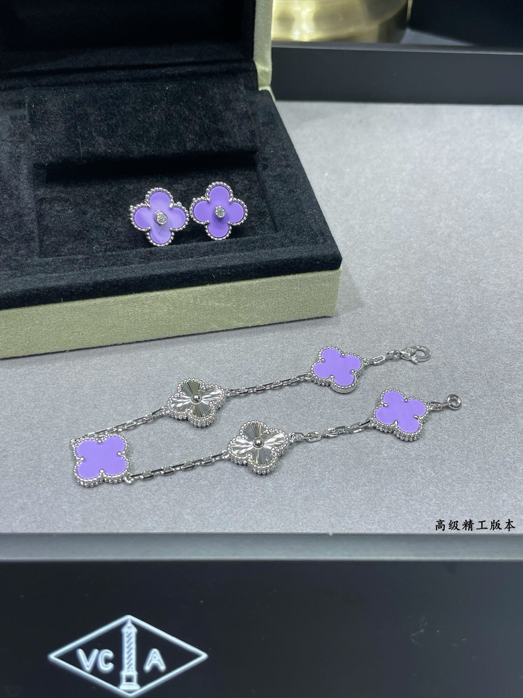 Lilac clover earrings and matching bracelet displayed in a jewelry case