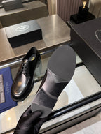 Black leather oxford shoes with lace-up front, showing inner sole and stitching