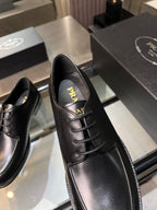 Black leather oxford shoe close-up with lace-up eyelets and PRADA logo