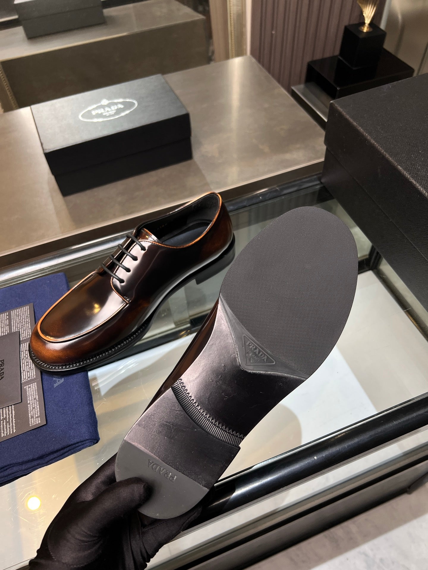 Brown leather lace-up shoes with matching black socks in display tray