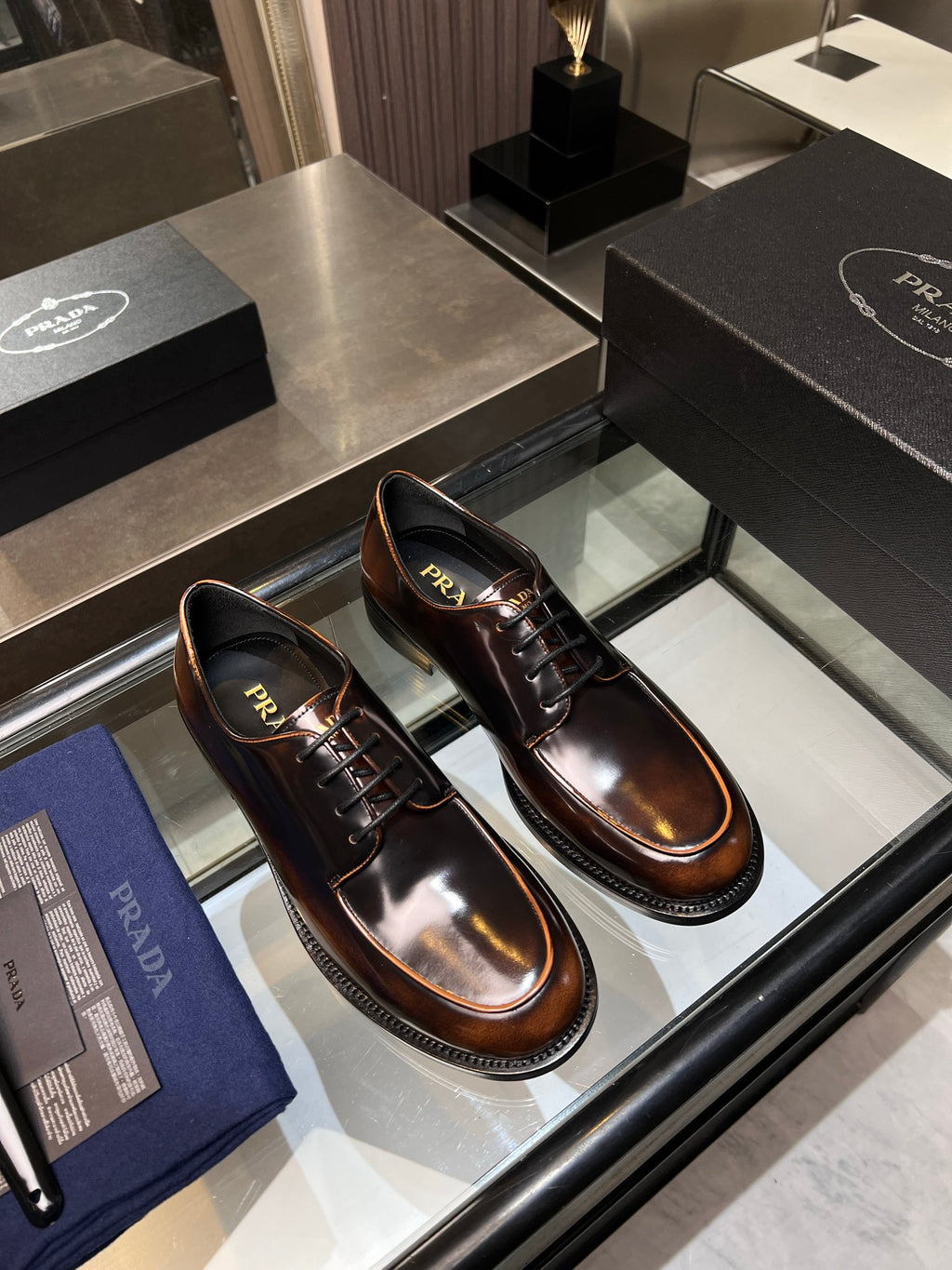 Pair of dark brown leather lace-up shoes with lace-up front and side stitching
