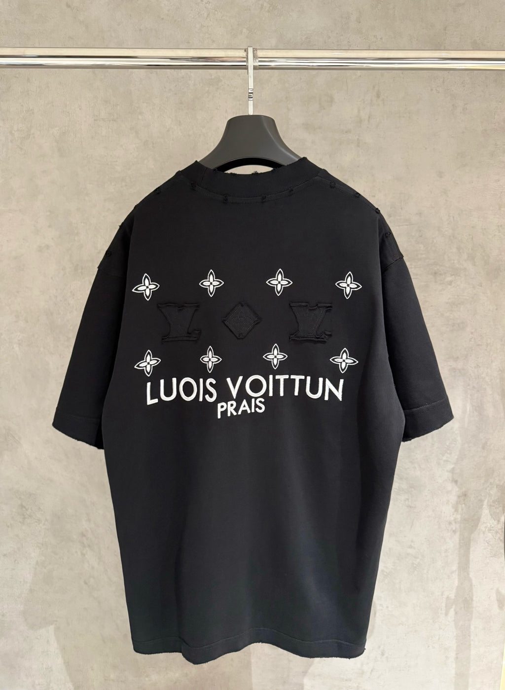 Louis Vuitton black T-shirt with back graphic of white flowers and 'LOUIS VUITTON PRAIS'