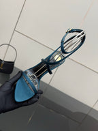 Blue strappy sandal side view with thin straps and high stiletto heel